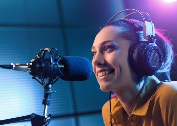 Smiling woman doing podcasts to support your sobriety